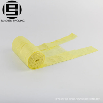 Yellow colored t-shirt rolling trash bags for car